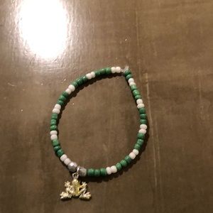 Homemade green and white bracelet with charm